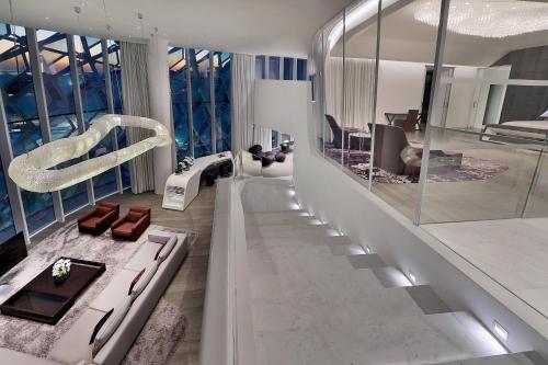 a living room with a staircase with glass walls at W Abu Dhabi - Yas Island in Abu Dhabi