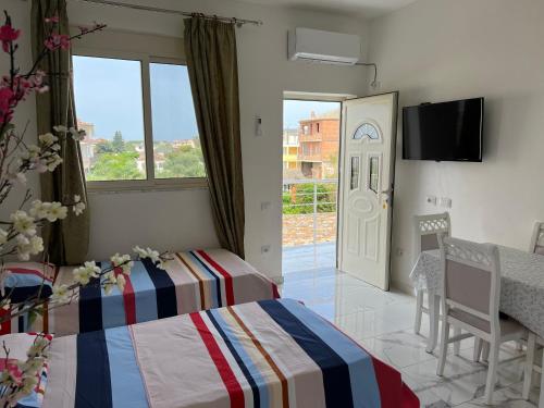 a bedroom with a bed and a sliding glass door at Kleida Beach Vacation Rentals in Spille