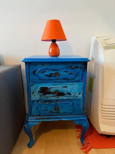 a blue dresser with a lamp on it next to a computer at Ana in Paraćin