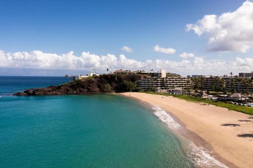 an aerial view of a beach in front of condos at Sheraton Maui Resort & Spa in Lahaina