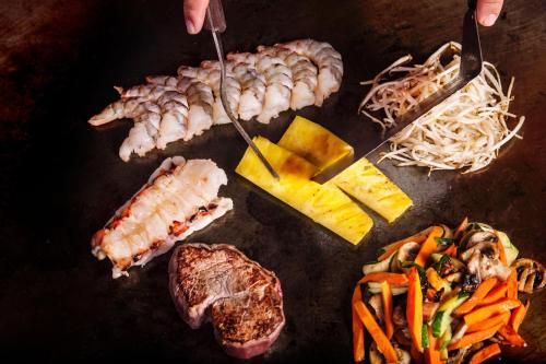 a bunch of different types of food on a table at Sheraton Maui Resort & Spa in Lahaina