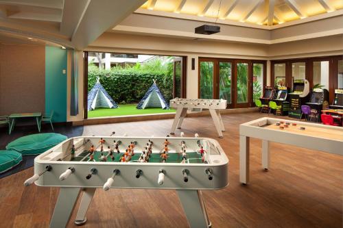 a living room with a foos ball and a table at Sheraton Maui Resort & Spa in Lahaina