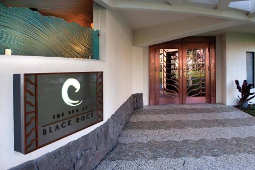 a building with a black door with a sign on it at Sheraton Maui Resort & Spa in Lahaina