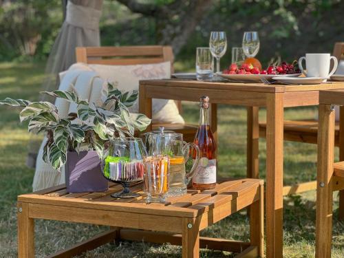 a picnic table with wine glasses and a plate of fruit at Margate Accommodation in Haapsalu