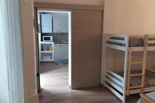 a small room with a bunk bed and a kitchen at Dream House in Clusone