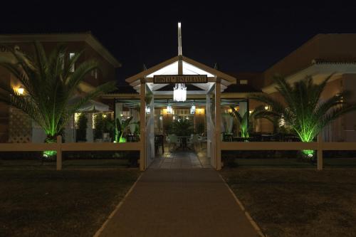 a gazebo with a street sign at night at Hostal Rte. Casa Miguel in Matalascañas