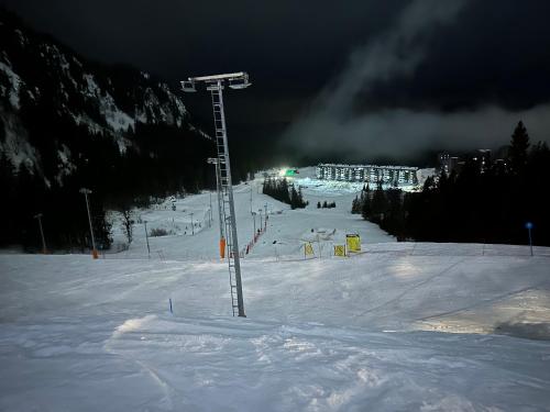 a snow covered ski slope with a ski lift at Dana Apartmani in Kopaonik