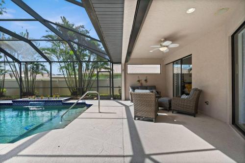 a home with a swimming pool and a patio at Cozy 3BR Gulf Coast house with heated pool in Englewood