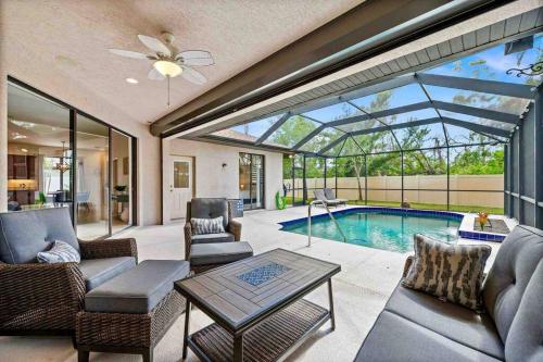 a living room with a pool and a glass ceiling at Cozy 3BR Gulf Coast house with heated pool in Englewood