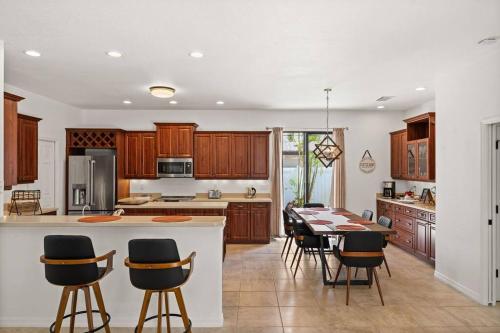 a kitchen and dining room with a table and chairs at Cozy 3BR Gulf Coast house with heated pool in Englewood