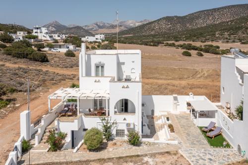an aerial view of a white house with mountains in the background at Ocean Blue Villa in Agiassos
