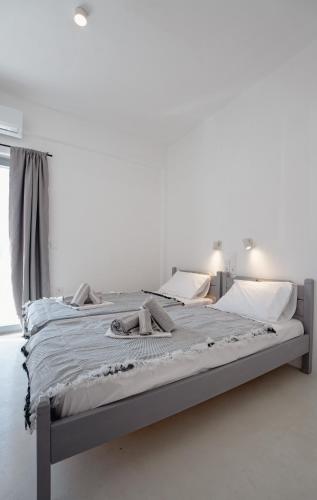 a bed in a white room with a bedvisor at Saint Barbara luxury home in Dhragoulás