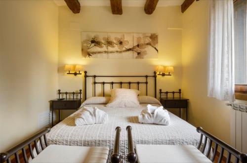 a bedroom with a bed with two pillows on it at Las Casas De Satue in Satué