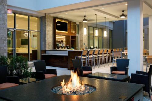 a fire pit in a restaurant with a bar at SpringHill Suites by Marriott Orlando Theme Parks Lake Buena Vista in Orlando