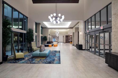 an empty lobby with a chandelier in a building at SpringHill Suites by Marriott Orlando Theme Parks Lake Buena Vista in Orlando