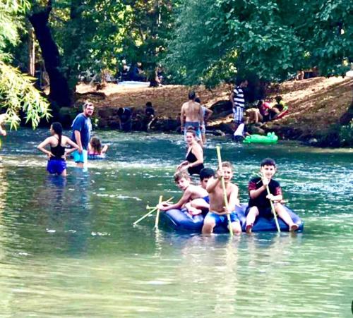 a group of people in the water in a river at לארח, זה בטבע שלנו in Kefar Blum