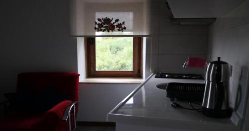 a small kitchen with a window and a counter top at Çeşmeli Konak in Canakkale