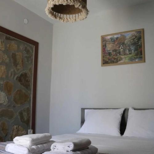 a bedroom with a bed with two towels on it at Çeşmeli Konak in Canakkale