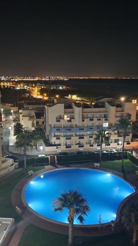 a large swimming pool in front of a large building at La Manga del Mar Menor Los Miradores block 1 5th floor G in Murcia