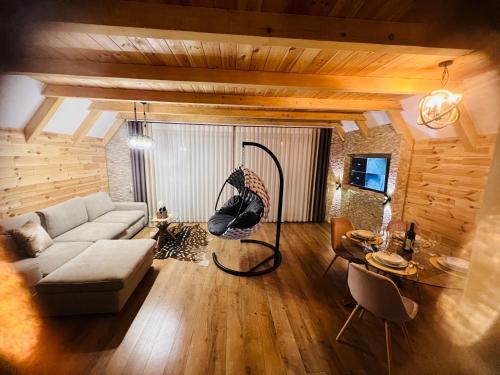 a living room with a couch and a swing at Prima Vista in Žabljak