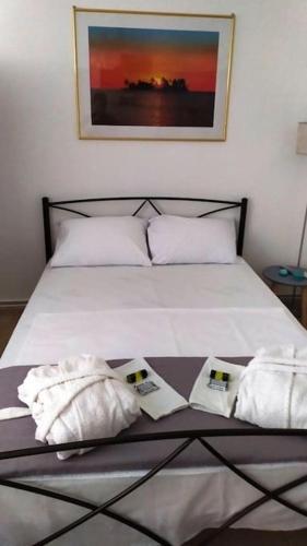 a bedroom with a bed with two towels on it at Κεντρικό στούντιο στην Καρδίτσα. in Karditsa