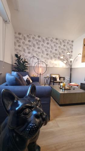 a living room with a black cat statue in front of a couch at BauHaus - Sleepwithme - Free Parking - Free Braeakfast - Very Friendly Staff in Pisa