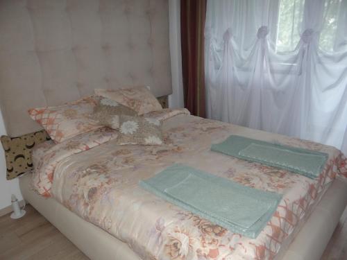 a bed with two towels on top of it at Apartament de lux white&red in Suceava