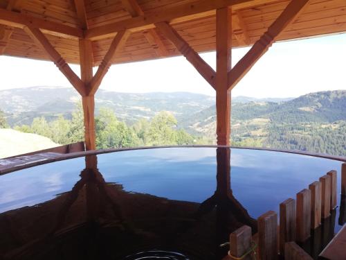 a view from the inside of a cabin with a view of the water at Cabana Trif in Horea