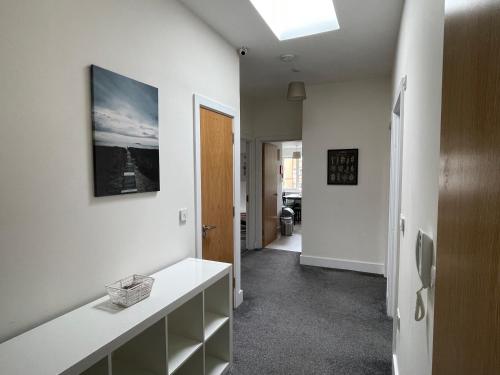 a room with a hallway with white walls and a ceiling at 2 Bedroom 2 bathroom Apartment 8 including free parking in Bromley
