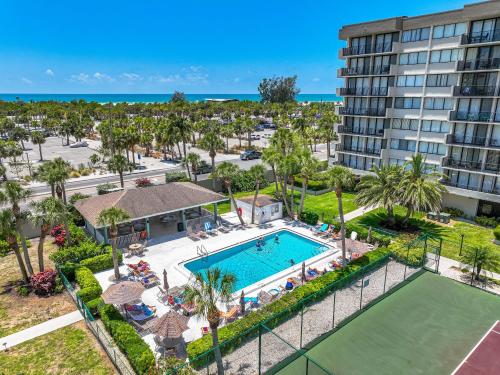 an aerial view of a resort with a pool and a tennis court at Our House at the Beach 501W By Beachside Management in Siesta Key