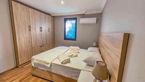 a bedroom with a bed with white sheets and pillows at Elasu Bodrum in Bodrum City