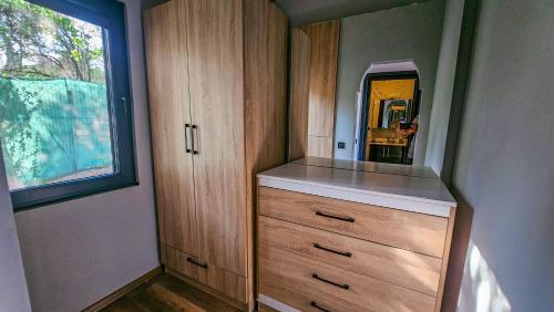 a bathroom with a dresser with a mirror on it at Elasu Bodrum in Bodrum City