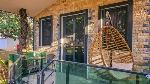 a porch with a rocking chair and a table at Elasu Bodrum in Bodrum City