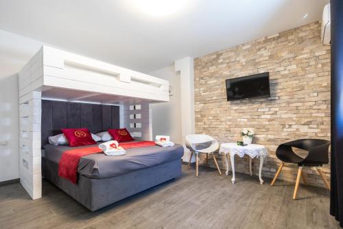 a bedroom with a bed with red pillows at Villa Mare in Klek