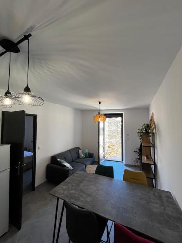 un salon avec une table et un canapé dans l'établissement La Patafiole Appartement T2 calme élégant, à Pont-de-Barret