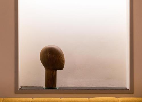 a wooden object sitting in a window at Dimora Collection - Le Torri - Boutique Luxury Suites - Adults Only in Florence