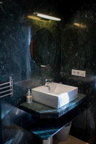 a bathroom with a sink and a mirror at Casa Mila with heated pool in El Roque in El Cotillo