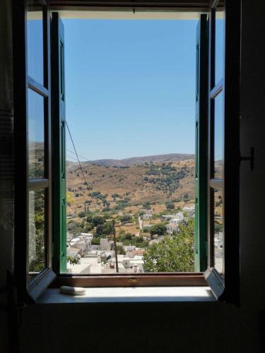 an open window with a view of a city at Με θέα το χωριό & το όρος Ζευς! in Apeiranthos
