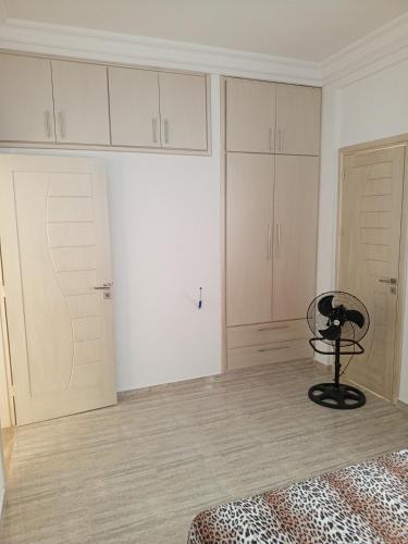 a bedroom with white cabinets and a chair in a room at Vue sur mer, 3 chambres, Construit en 2024, in Sousse