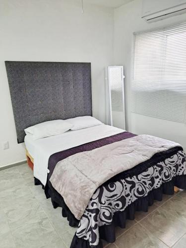 a bedroom with a large bed in a room at Blanco Sereno - Depto 2 - 2 Min Malecón in Mazatlán