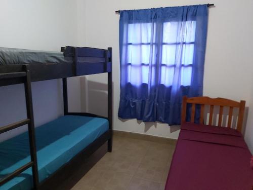 a bedroom with two bunk beds and a window at DON MIGUEL DEPARTAMENTOS in Puerto Iguazú