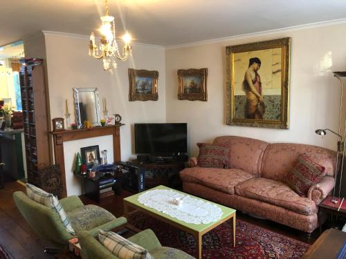 a living room with a couch and a table at House o' Books in London