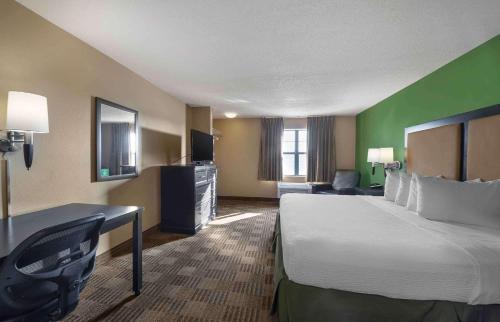 um quarto de hotel com uma cama grande e uma secretária em Extended Stay America Suites - Oklahoma City - Airport em Oklahoma City