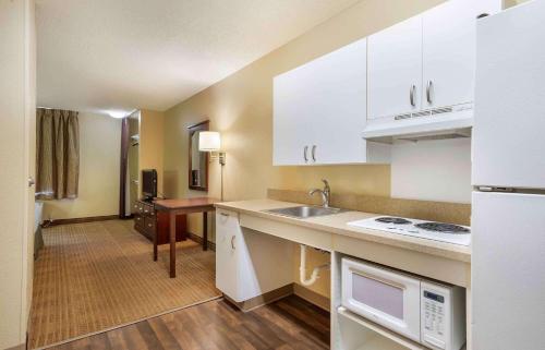 a kitchen with white cabinets and a sink at Extended Stay America Suites - Columbus - Bradley Park in Columbus