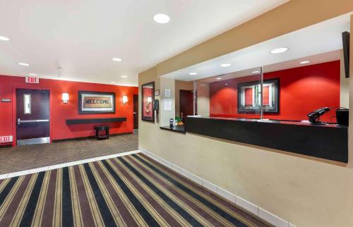 a large bathroom with red walls and a sink at Extended Stay America Suites - Cleveland - Brooklyn in Brooklyn