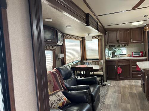 a living room with leather chairs and a table at Gorgeous Denali 5th Wheel Delight! in Walla Walla