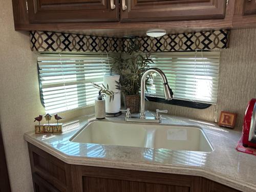 a kitchen counter with a sink and a window at Gorgeous Denali 5th Wheel Delight! in Walla Walla