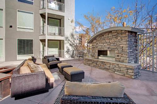 a patio with a stone fireplace and couches at Luxury Condo in the Library Square District in Salt Lake City