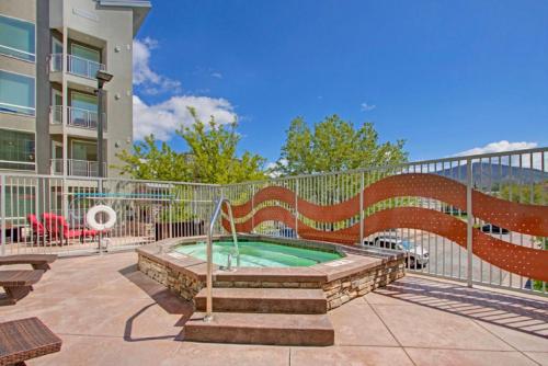 a patio with a hot tub and a fence at Luxury Condo in the Library Square District in Salt Lake City