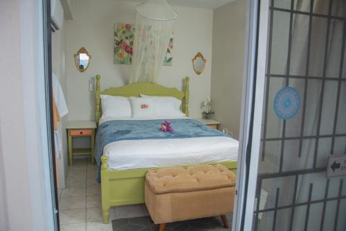 a bedroom with a bed with a teddy bear on it at Mountain View Apartments in Gros Islet